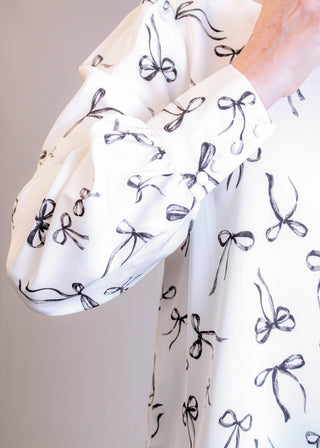 Blu Pepper Long Sleeve Blouse with Bow Print Detail View - Fashion Crossroads Inc