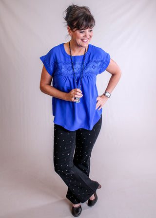 Blu Pepper Top with Eyelet Lace and Back Buttons modeled  view - Fashion Crossroads Inc.