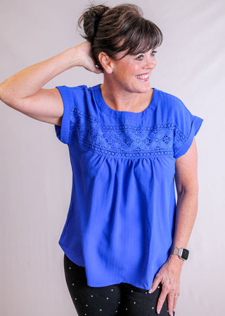 Blu Pepper Top with Eyelet Lace and Back Buttons front view - Fashion Crossroads Inc.